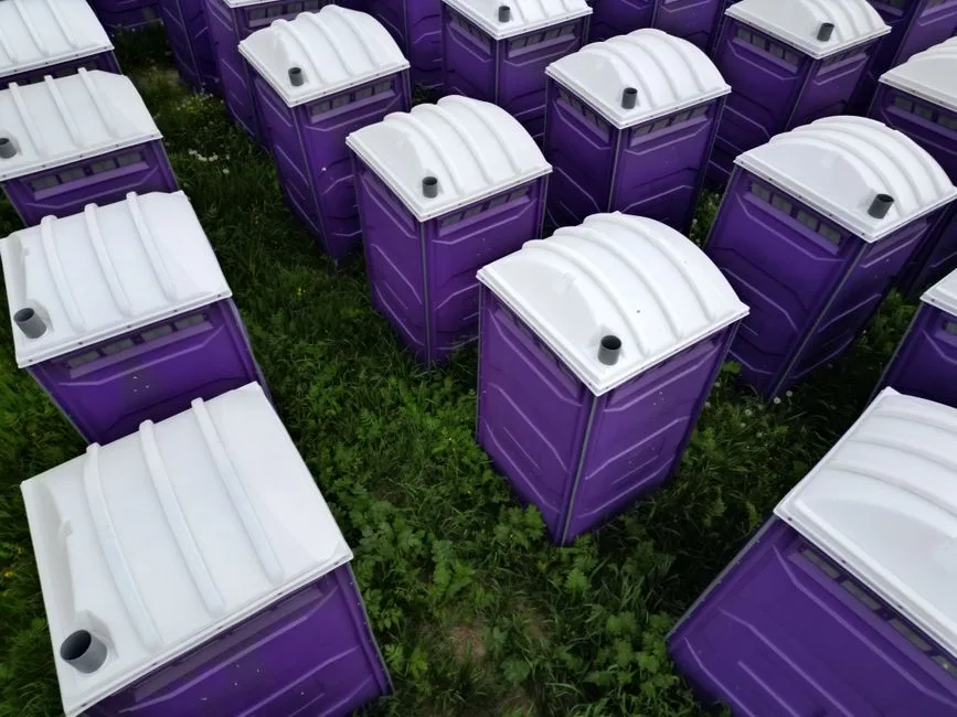 Bank of portable restrooms set up for an outdoor event